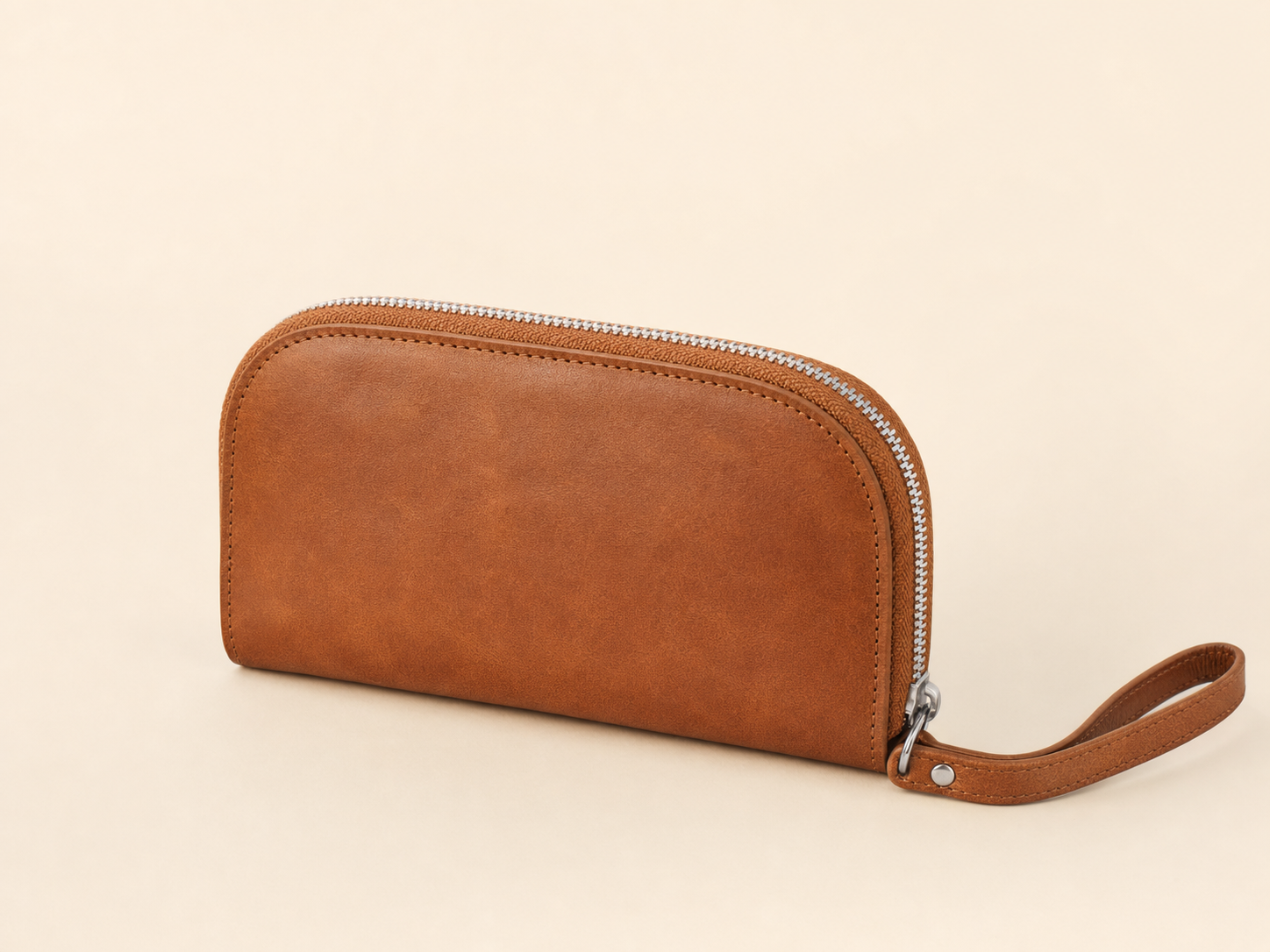 Tan leather curved wristlet wallet